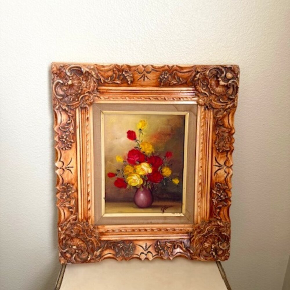 J. Berman painting still life painting of red and yellow roses in a vase